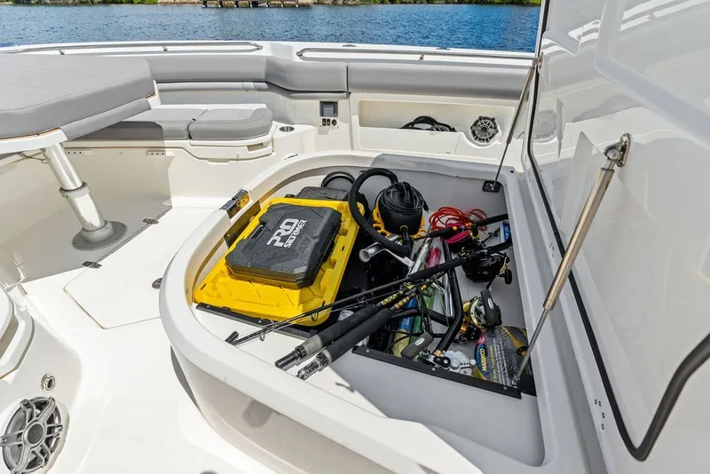 Slide: The Image of Storage compartment on 2023 Boston Whaler 380 Outrage boat, filled with fishing gear and equipment. - 29
