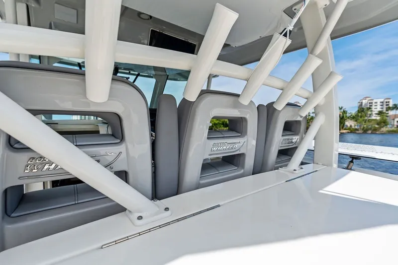 Slide: The Image of 2023 Boston Whaler 380 Outrage boat interior with rod holders and seating. - 39