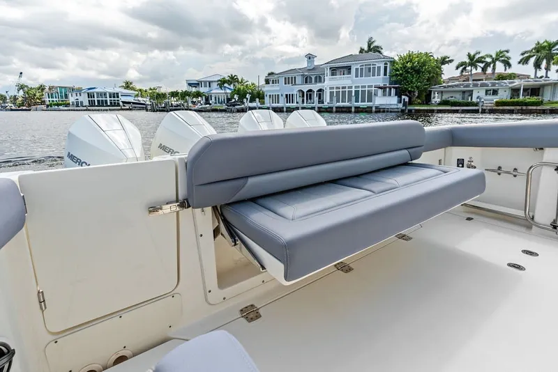 Slide: The Image of 2023 Boston Whaler 380 Outrage boat with seating, docked near waterfront homes. - 54