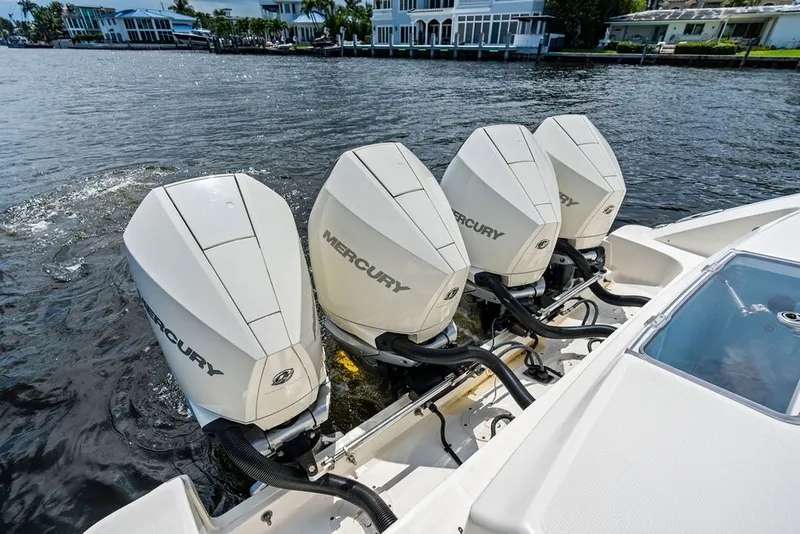 Slide: The Image of 2023 Boston Whaler 380 Outrage with four powerful Mercury outboard engines on water. - 50