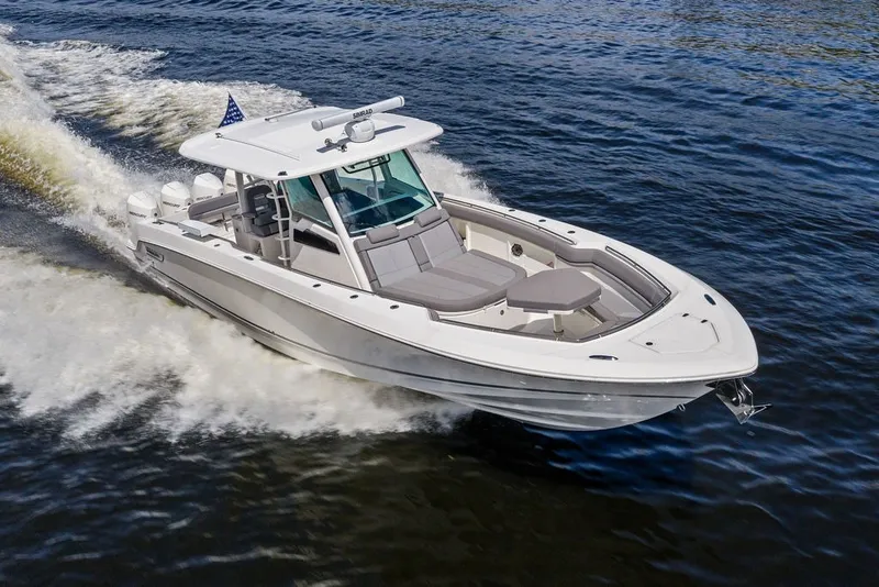 Slide: The Image of 2023 Boston Whaler 380 Outrage cruising on open water, showcasing sleek design and powerful performance. - 7
