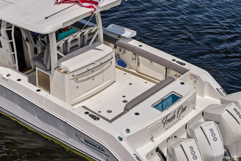Slide: The Image of 2023 Boston Whaler 380 Outrage boat with triple engines on water. - 17