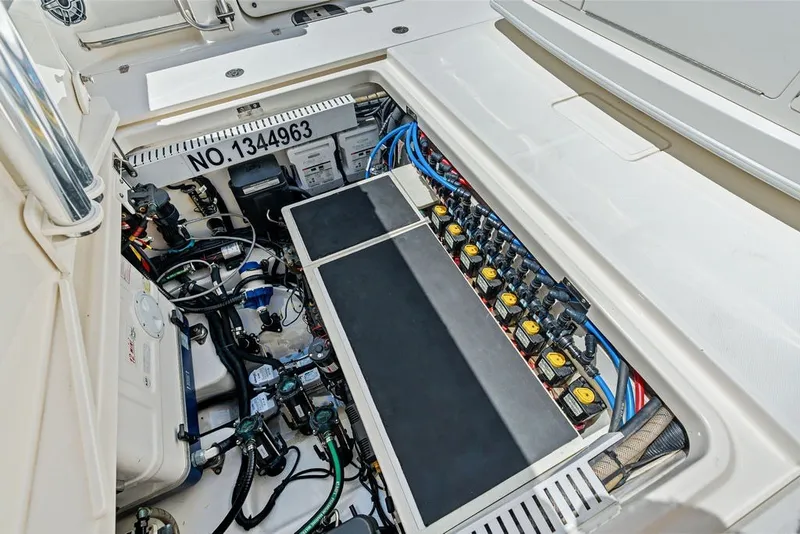 Slide: The Image of Engine compartment of 2023 Boston Whaler 380 Outrage, showcasing wiring and components. - 45