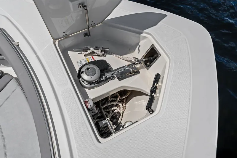 Slide: The Image of 2023 Boston Whaler 380 Outrage anchor storage compartment with ropes and winch. - 24
