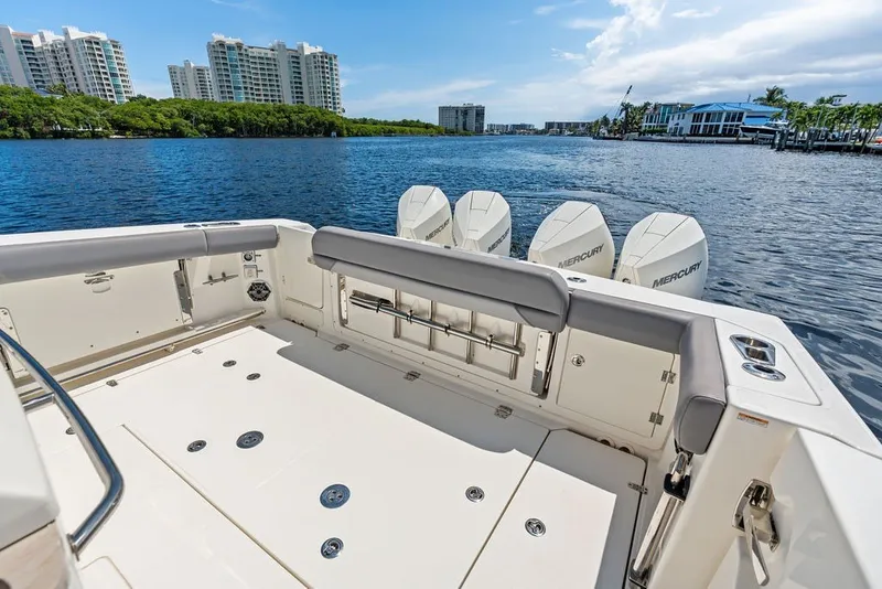 Slide: The Image of 2023 Boston Whaler 380 Outrage boat with Mercury engines on a scenic waterfront. - 52