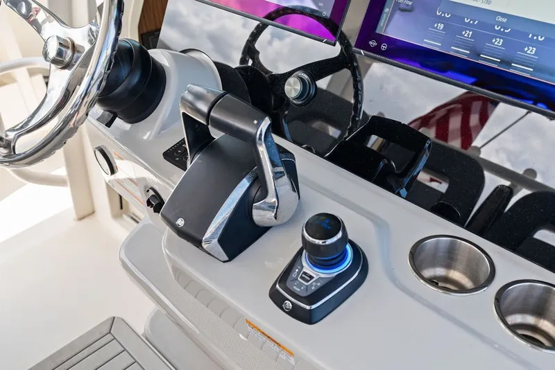 Slide: The Image of Control panel of 2023 Boston Whaler 380 Outrage with steering wheel and throttle. - 33