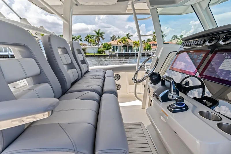 Slide: The Image of 2023 Boston Whaler 380 Outrage cockpit with luxurious seating and advanced navigation controls. - 37