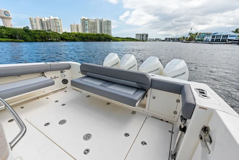 Slide: The Image of 2023 Boston Whaler 380 Outrage boat with Mercury engines, spacious deck, and waterfront view. - 53