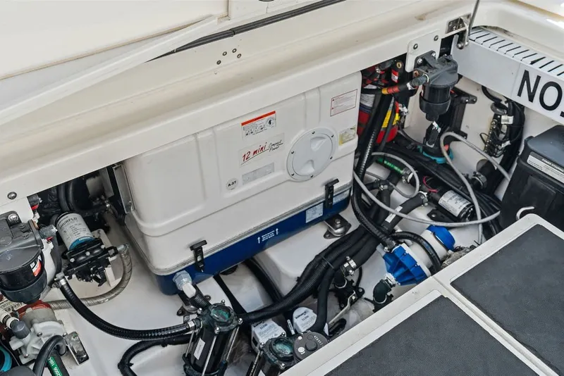 Slide: The Image of Engine compartment of 2023 Boston Whaler 380 Outrage, showcasing mechanical components and wiring. - 44