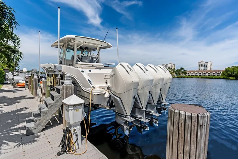 Slide: The Image of 2023 Boston Whaler 380 Outrage docked with four powerful outboard engines. - 19