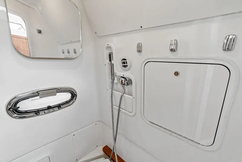 Slide: The Image of Interior of 2023 Boston Whaler 380 Outrage boat, featuring a sleek, modern bathroom design. - 58