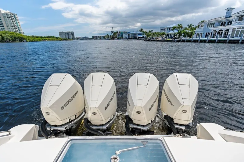 Slide: The Image of 2023 Boston Whaler 380 Outrage with four Mercury outboard engines on a scenic waterway. - 51