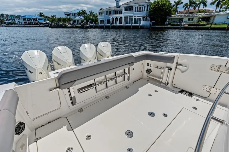 Slide: The Image of 2023 Boston Whaler 380 Outrage boat deck with quad Mercury engines, dockside view. - 49