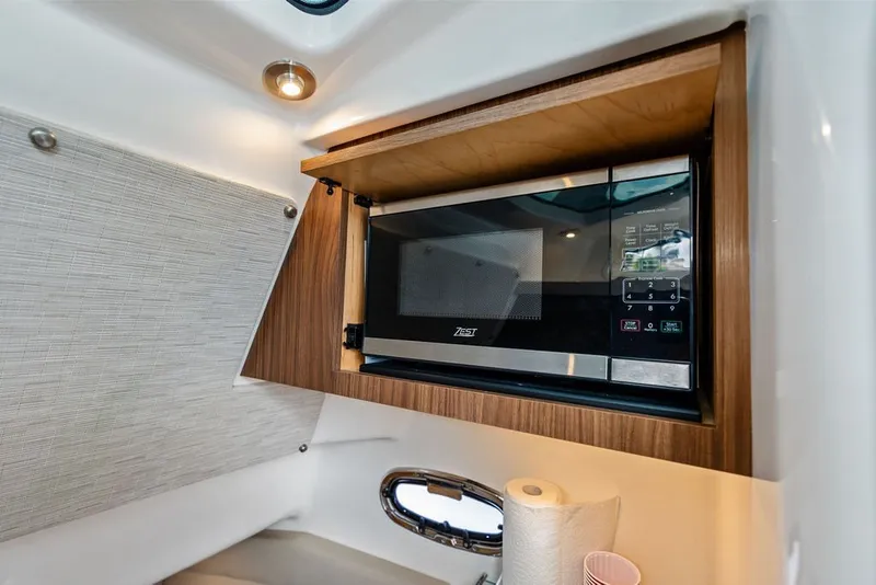 Slide: The Image of 2023 Boston Whaler 380 Outrage interior with built-in microwave and modern cabinetry. - 59