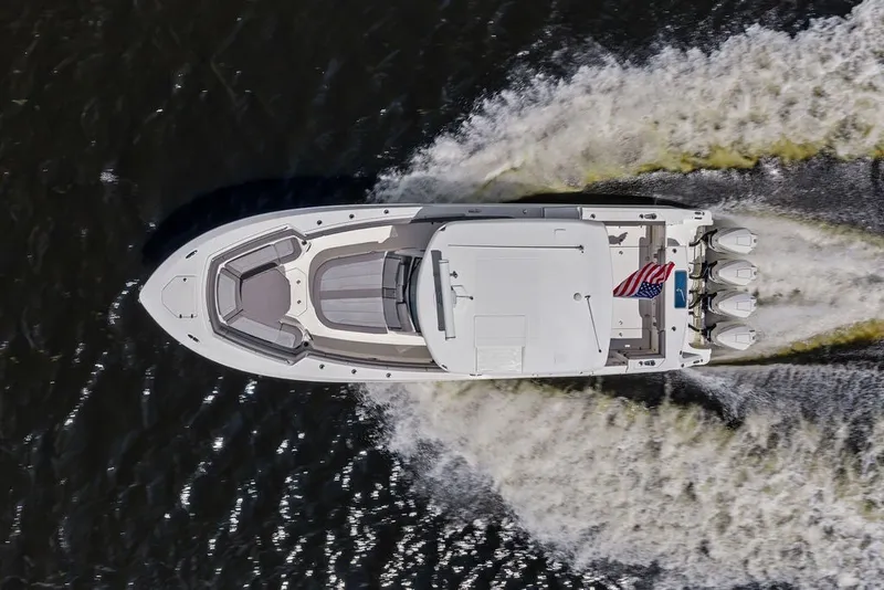 Slide: The Image of Aerial view of 2023 Boston Whaler 380 Outrage cruising on water. - 5