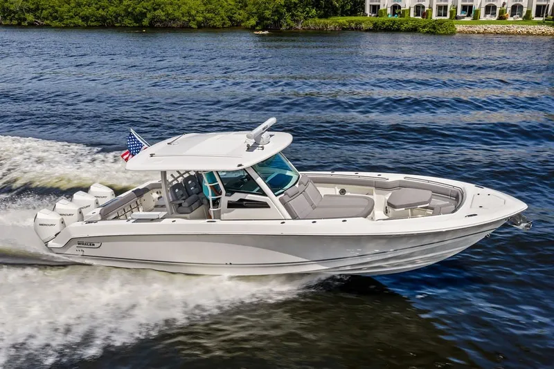The Image of 2023 Boston Whaler 380 Outrage cruising on a scenic waterway. - 0