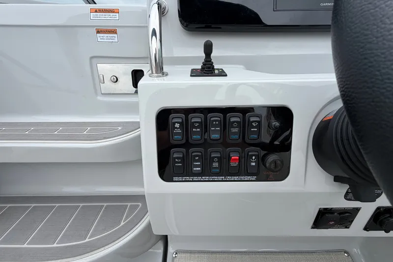 Slide: The Image of Control panel of a 2021 Regal 26 Express boat with various switches and warnings. - 21