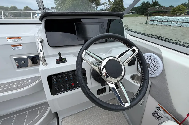 Slide: The Image of 2021 Regal 26 Express boat dashboard with steering wheel and control panel. - 19