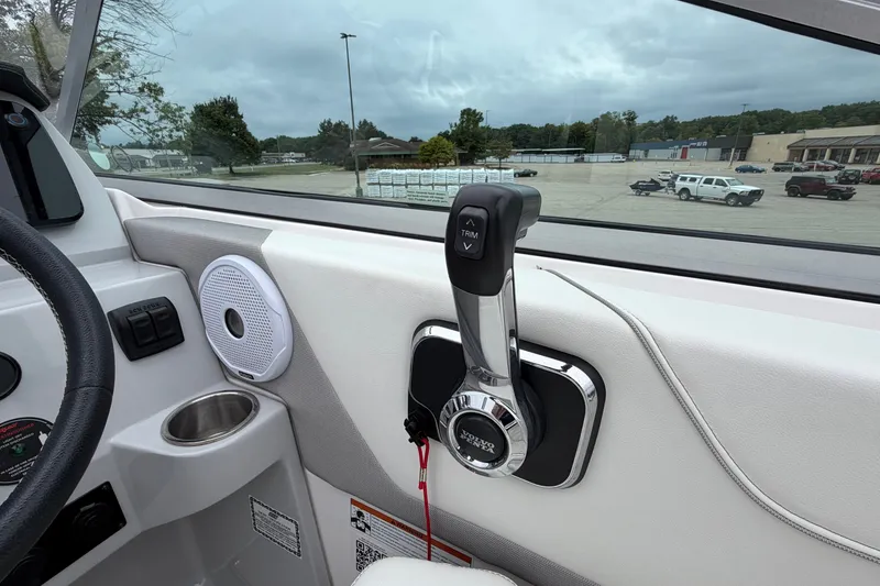 Slide: The Image of Interior view of a 2021 Regal 26 Express boat, featuring throttle controls and speaker. - 23