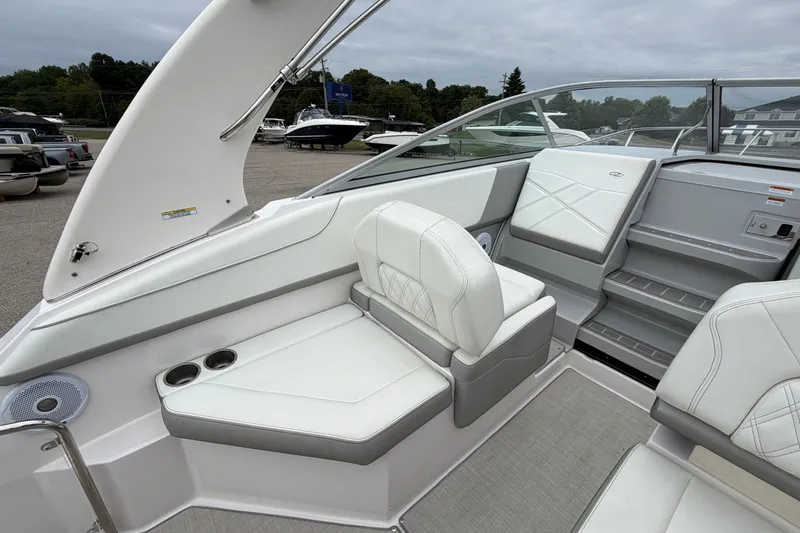 Slide: The Image of 2021 Regal 26 Express boat interior with white seating and cup holders. - 17