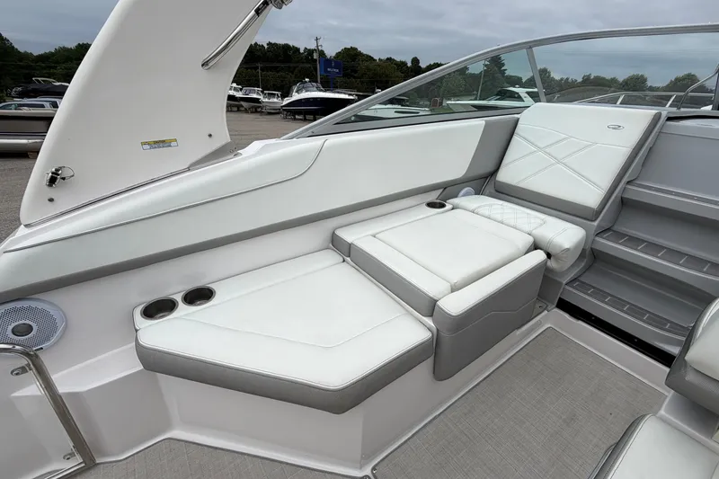 Slide: The Image of 2021 Regal 26 Express boat interior with white seating and cup holders. - 18