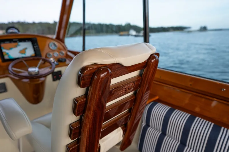 Slide: The Image of Interior of 2018 Hinckley Picnic Boat 34 MKII with wooden helm and striped seating. - 22