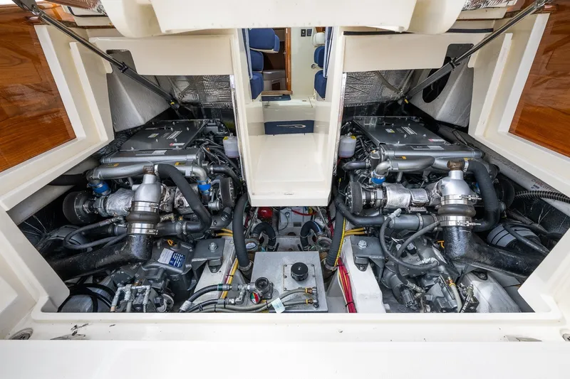 Slide: The Image of Engine compartment of 2018 Hinckley Picnic Boat 34 MKII, showcasing dual engines and mechanical components. - 29