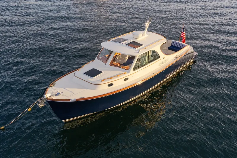 Slide: The Image of 2018 Hinckley Picnic Boat 34 MKII on calm water, showcasing elegant design and craftsmanship. - 5