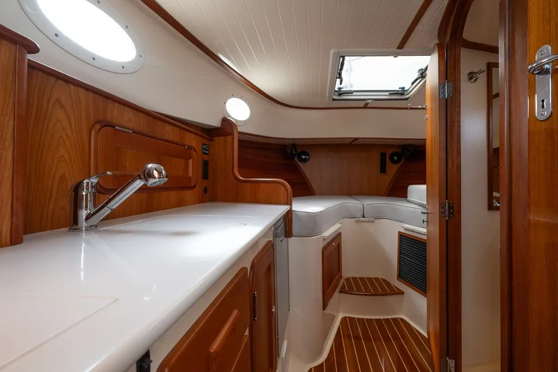 Slide: The Image of Interior of 2018 Hinckley Picnic Boat 34 MKII, featuring elegant wood finishes and modern amenities. - 24
