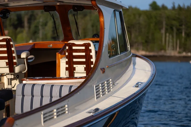 Slide: The Image of 2018 Hinckley Picnic Boat 34 MKII on serene water, showcasing elegant design and luxurious seating. - 32