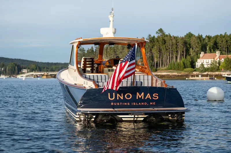 Slide: The Image of Hinckley Picnic Boat 34 MKII, 2018, on water with American flag, Bustins Island, ME. - 1