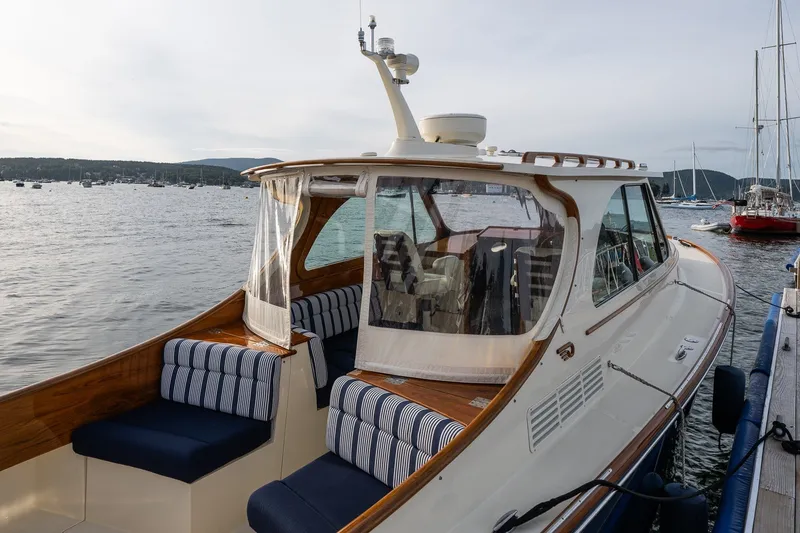 Slide: The Image of 2018 Hinckley Picnic Boat 34 MKII docked, featuring elegant seating and scenic waterfront view. - 12