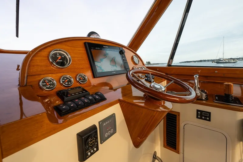 Slide: The Image of Helm of 2018 Hinckley Picnic Boat 34 MKII with navigation instruments and wooden steering wheel. - 19