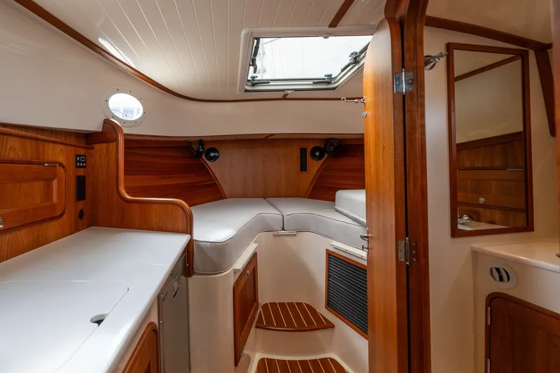 Slide: The Image of Interior of 2018 Hinckley Picnic Boat 34 MKII with wood finish and cozy seating. - 23