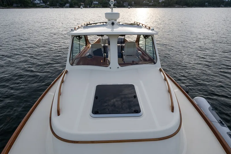 Slide: The Image of 2018 Hinckley Picnic Boat 34 MKII on calm water at sunset. - 7