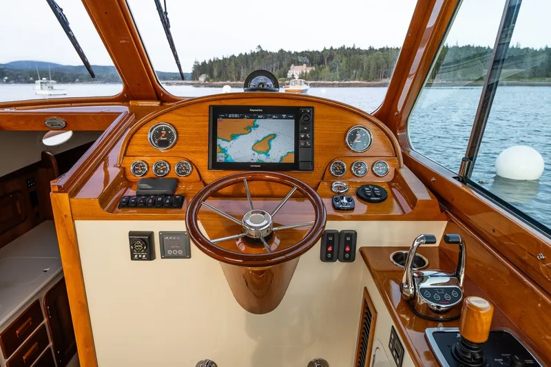 Slide: The Image of Helm of 2018 Hinckley Picnic Boat 34 MKII with navigation display and wooden steering wheel. - 20