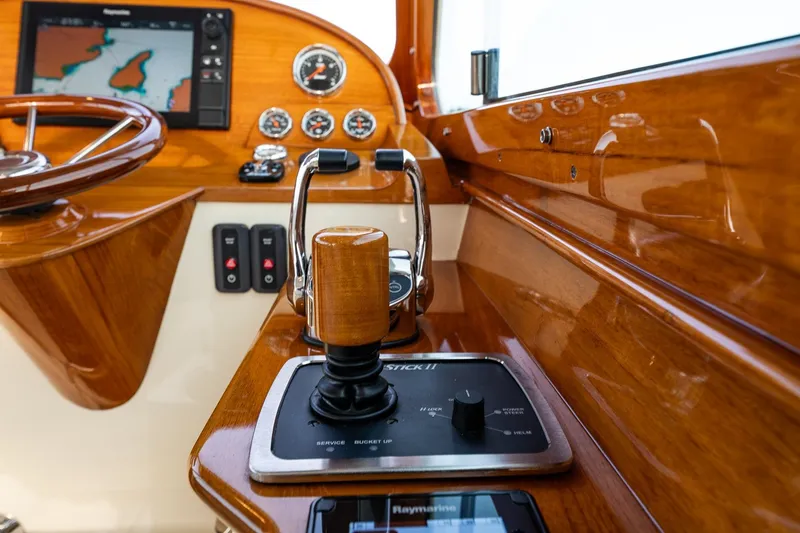 Slide: The Image of Hinckley Picnic Boat 34 MKII 2018 helm with wooden controls and navigation display. - 21