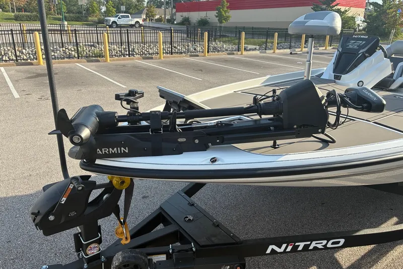 Slide: The Image of 2026 Nitro Z21 XL Pro boat with Garmin equipment on a trailer in a parking lot. - 8