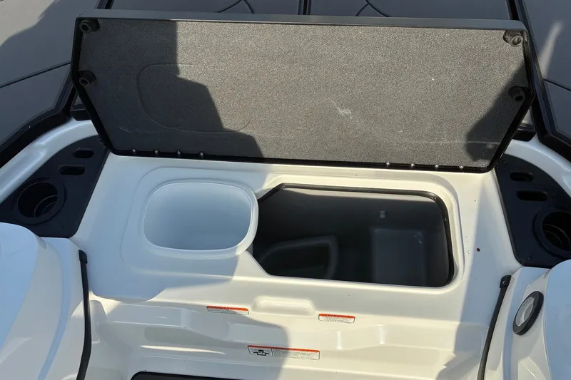 Slide: The Image of Open storage compartment on 2026 Nitro Z21 XL Pro boat, featuring cup holders and storage bins. - 14