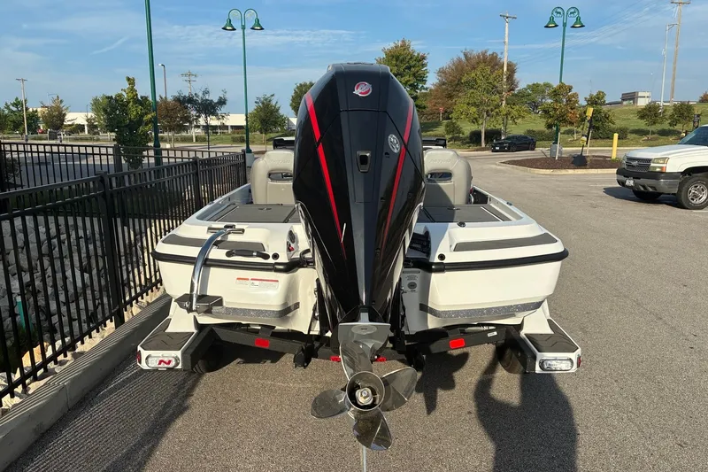 Slide: The Image of 2026 Nitro Z21 XL Pro boat with powerful outboard motor, parked in a lot. - 1