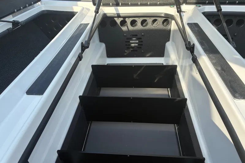 Slide: The Image of 2026 Nitro Z21 XL Pro boat storage compartments with open lids and organized interior. - 16