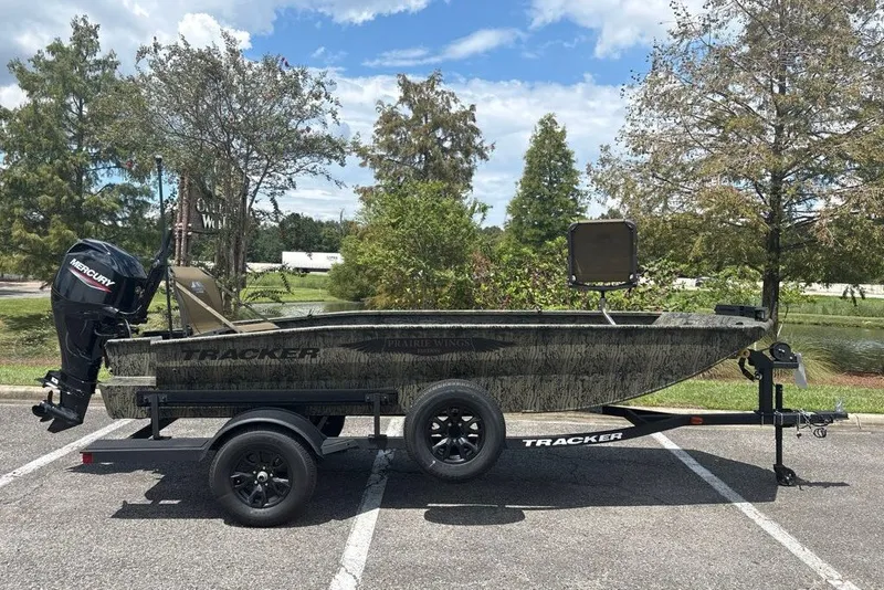 The Image of 2027 Tracker Grizzly 1650 T Prairie Wings Edition boat on trailer in parking lot. - 0