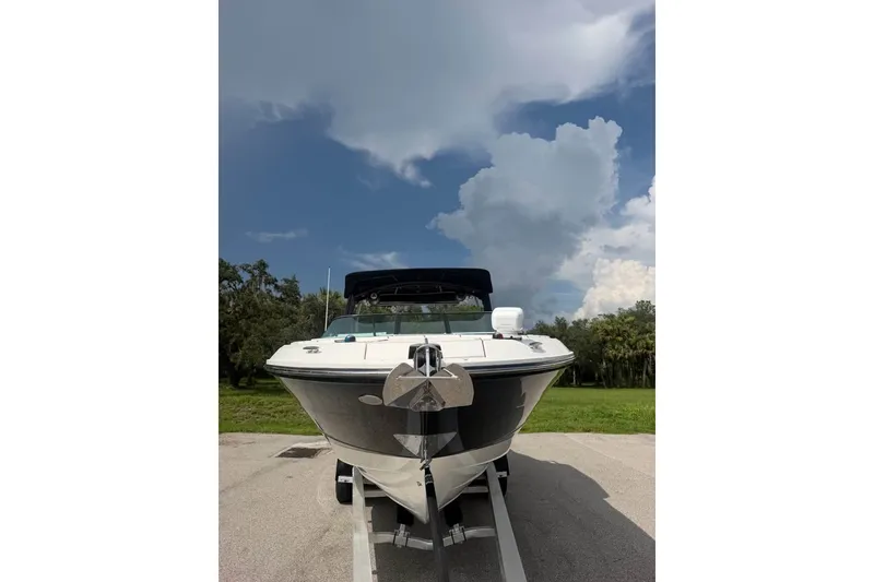 Slide: The Image of 2019 Sea Ray SLX 310 Outboard boat on trailer under cloudy sky. - 9