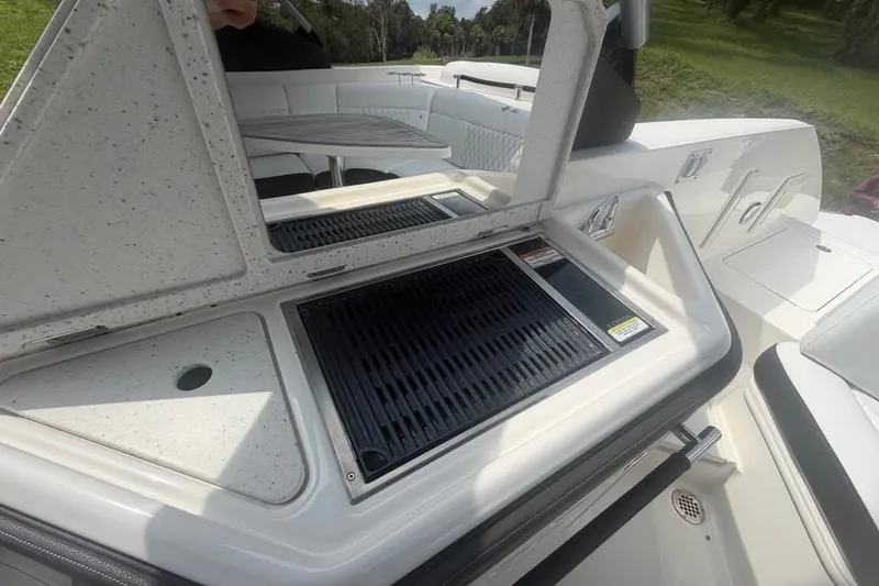 Slide: The Image of 2019 Sea Ray SLX 310 Outboard boat with onboard grill and seating area. - 15