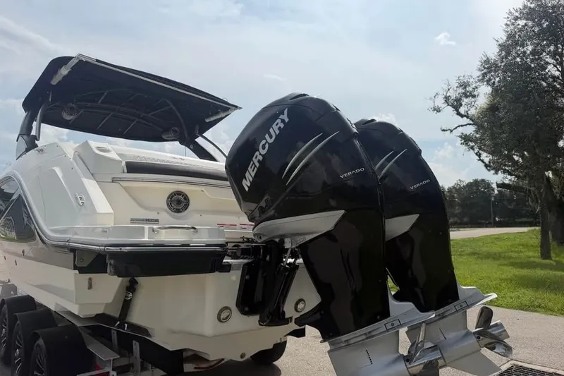 Slide: The Image of 2019 Sea Ray SLX 310 Outboard with dual Mercury Verado engines on a trailer. - 8