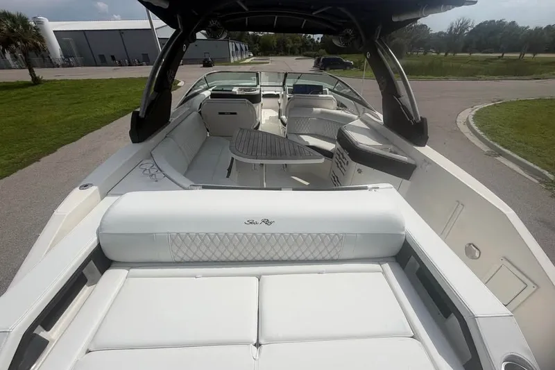 Slide: The Image of 2019 Sea Ray SLX 310 Outboard boat interior with luxurious seating and sleek design. - 12