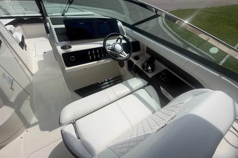 Slide: The Image of 2019 Sea Ray SLX 310 Outboard cockpit with modern steering and control panel. - 14