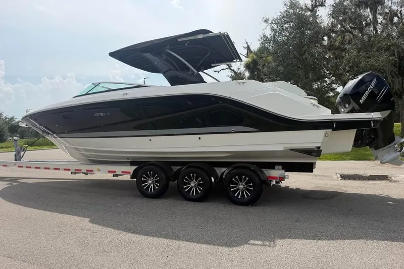 Slide: The Image of 2019 Sea Ray SLX 310 Outboard boat on a trailer, parked outdoors. - 6