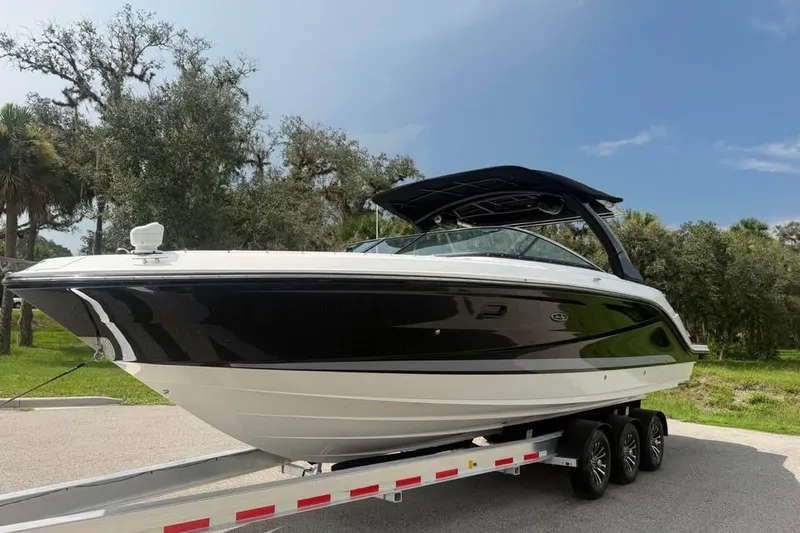 Slide: The Image of 2019 Sea Ray SLX 310 Outboard boat on trailer, parked outdoors. - 4