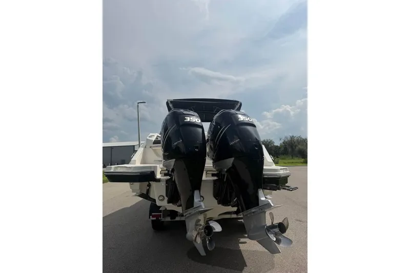 Slide: The Image of 2019 Sea Ray SLX 310 Outboard with twin 350 engines, rear view on pavement. - 18